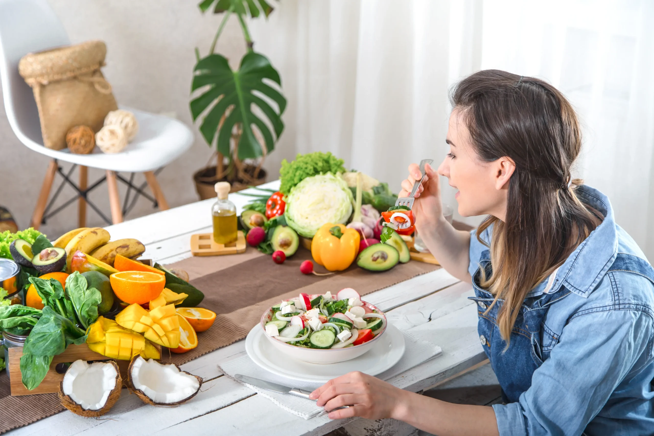 young-happy-woman-eating-salad-table.webp